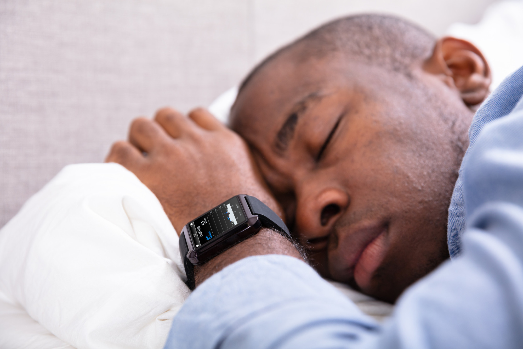 Man Sleeping With Smart Watch In His Hand